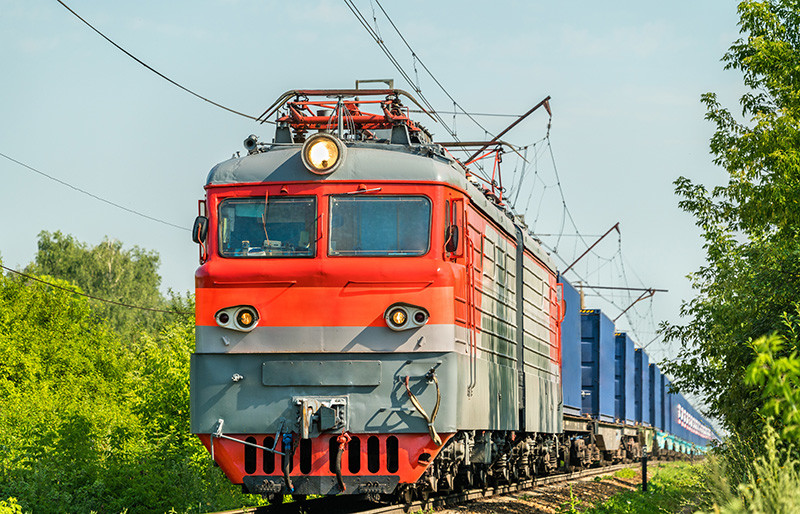 Rail transport - important part of transportation - freight train - red electric locomotive with wagons